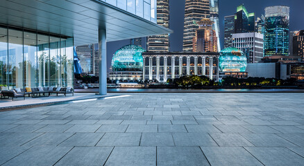 Fototapeta na wymiar Empty square floor and modern city buildings in Shanghai at night, China.