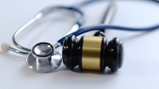 Gavel and stethoscope. medical jurisprudence. legal definition of medical malpractice. attorney. common errors doctors, nurses and hospitals make. Close-up shooting stock footage. slow motion