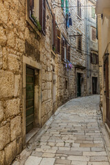 Fototapeta na wymiar Narrow stone alley in Sibenik, Croatia