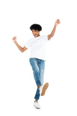 full length view of african american man in jeans and t-shirt dancing on white.