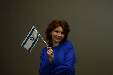 Young girl portrait over gray background. Isolated. Girk with israeli flag. space for the text.