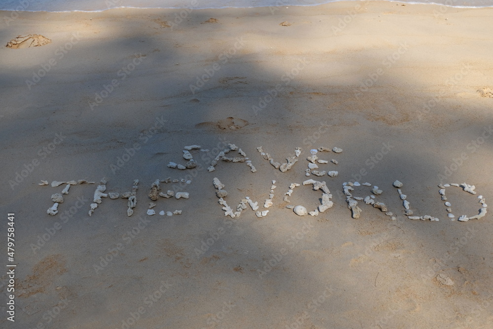 Fototapete the shell is arranged as a message of protecting the world on the sandy beach.