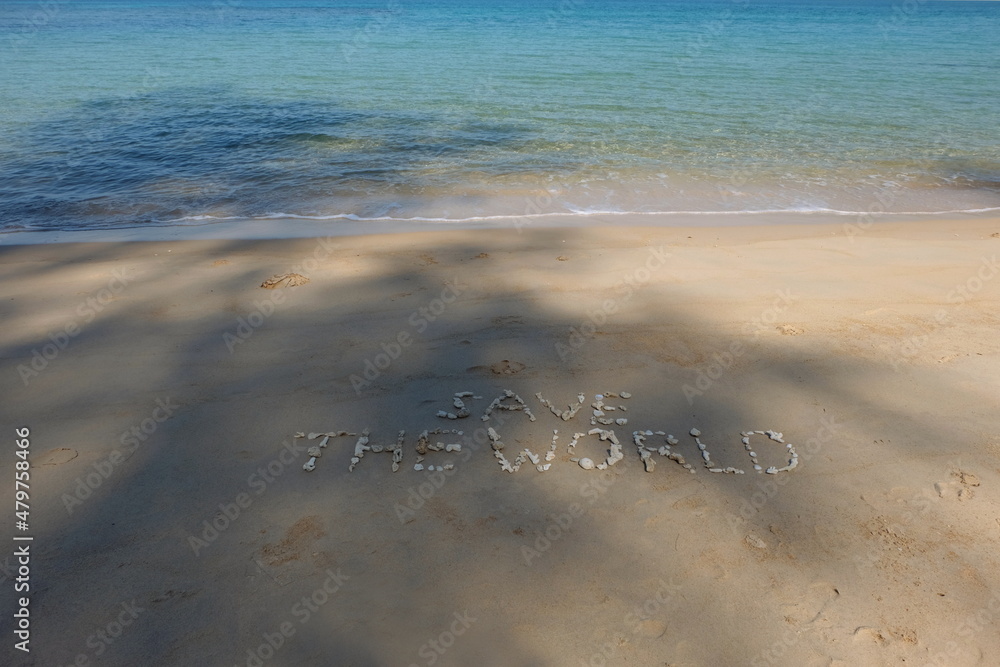 Fototapete the shell is arranged as a message of protecting the world on the sandy beach.