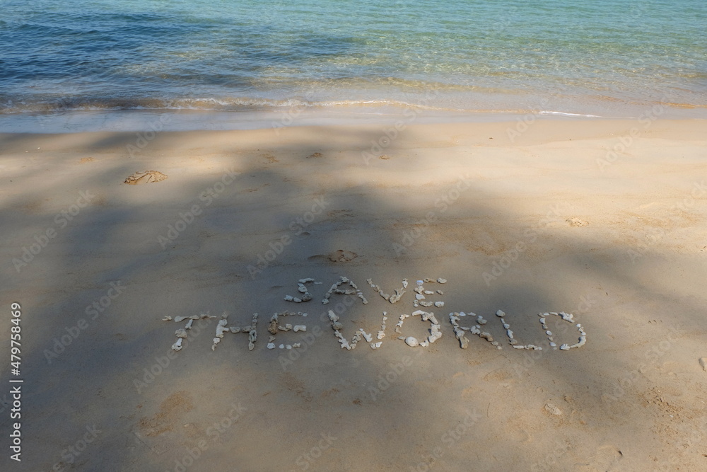 Fototapete the shell is arranged as a message of protecting the world on the sandy beach.