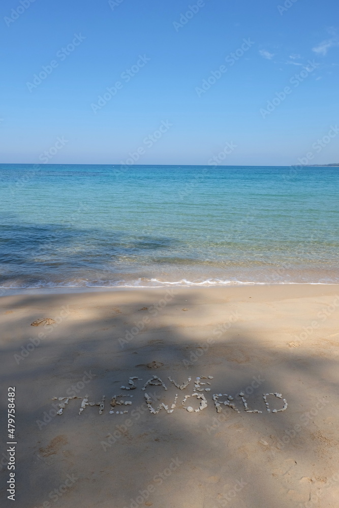 Fototapete the shell is arranged as a message of protecting the world on the sandy beach.