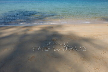 The shell is arranged as a message of protecting the world on the sandy beach.