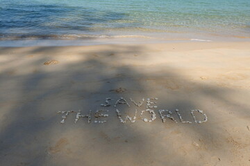 The shell is arranged as a message of protecting the world on the sandy beach.