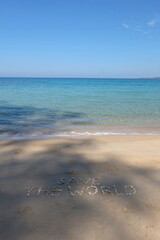The shell is arranged as a message of protecting the world on the sandy beach.