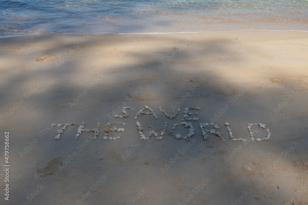 Fototapete the shell is arranged as a message of protecting the world on the sandy beach.
