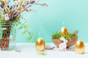 Happy Easter background, spring-time concept. Golden eggs, nests and bunny toys on blue