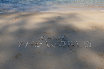 The shell is arranged as a message of protecting the world on the sandy beach.