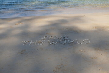 The shell is arranged as a message of protecting the world on the sandy beach.