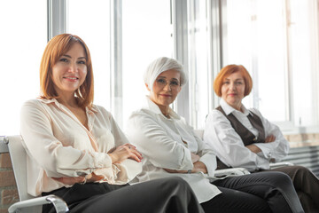 Portrait of three adults successful business lady	