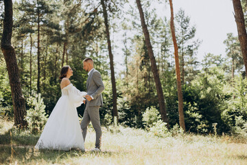 Groom and bride on their wedding day in forest