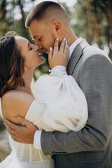 Fototapeta premium Groom and bride on their wedding day in forest