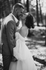 Young wedding couple having photoshoot in forest