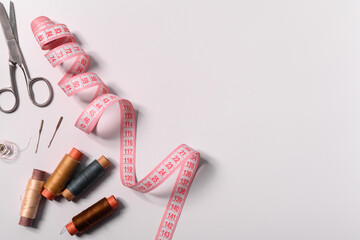 sewing tools and accessories on a white background. copy space