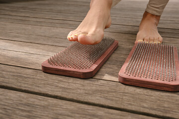The practice of self-knowledge in the park. A woman with a pedicure stands on sharp nails. Female...