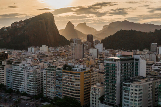 Aerial View of Buildings in Copacabana District With Mountains in the Horizon by Sunset in Rio de Janeiro, Brazil