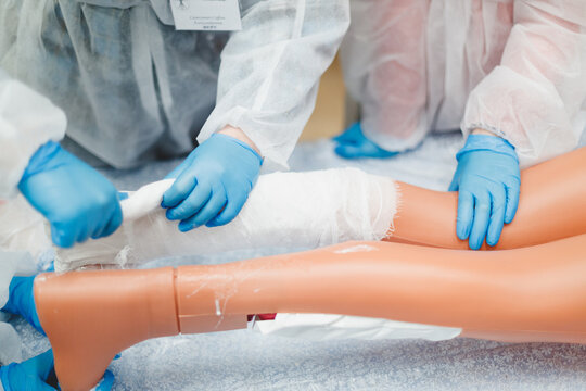 Medical Students On A Mannequin Train On A Mannequin To Apply A Cast