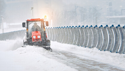 Tractor clear snow from pedestrian zone on car bridge, sidewalk snow management in the city during...