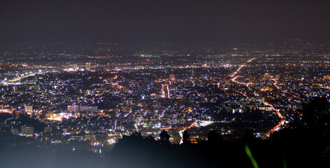 Fototapeta na wymiar City night lights view from mountain of Chiang Mai Thailand with skyline.