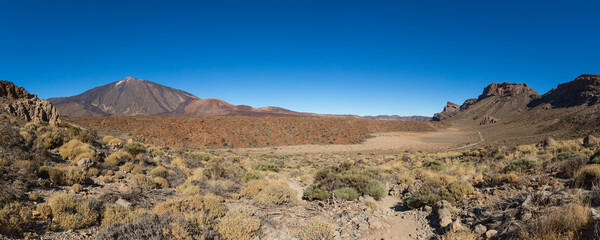 panorama of Teide mountain and lava fields on Tenerife with blue sky
