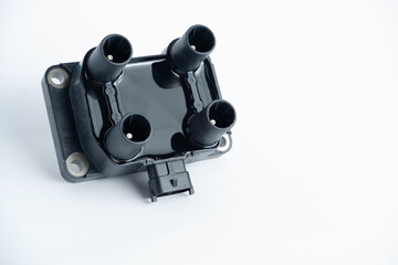 Fototapeta na wymiar Auto parts. Car ignition coil on a white background close-up. Ignition coil for gasoline four-cylinder internal combustion engine