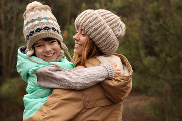 Obraz premium Woman and her son spending time together in forest