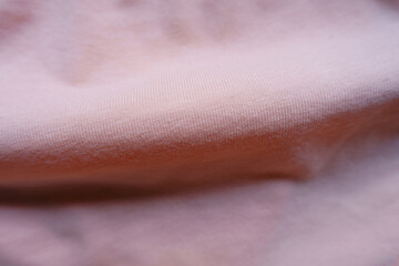 Horizontal soft fold on light pink cotton jersey fabric