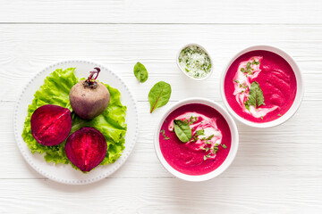 Cream soup made of red beet with raw beet roots