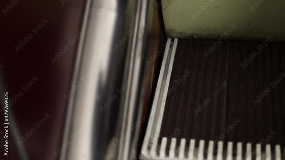 Poster step of the escalator going up close-up
