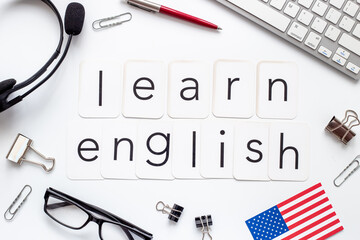 Learning English language concept. Text on student table desk, top view