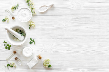 White medical herbal cosmetics in flowers - with skin cream and bath salt