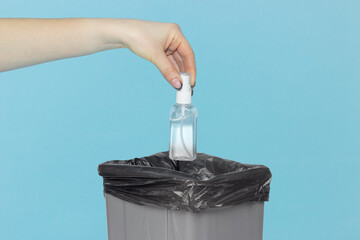 throw spray, atiseptic in trash can, spray bottle in hand in front of trash can, medical supplies...