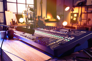 Microphone over professional mixing console on table in radio studio