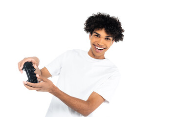 KYIV, UKRAINE - APRIL 10, 2020: cheerful african american man gaming with joystick isolated on white.