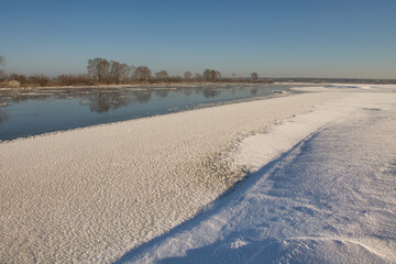 winter landscape. morning frost and sun. ice drift on the river. the branches of plants are covered with white frost