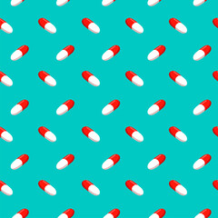 Pills on a turquoise background. Vector seamless pattern.