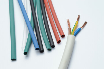 heat shrink tubing and a three-core stripped wire on a white background.