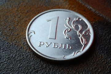 a Russian one ruble coin lies on a dark metal background. close-up