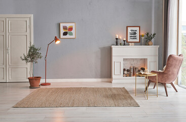 Naklejka premium Modern room concept interior style, chair fireplace frame wicker carpet decoration, grey stone wall background.