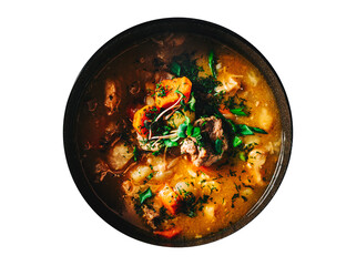 Pichelsteiner meat soup with vegetables in bowl isolated on white background