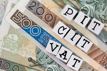 The wording "PIT" , "CIT" , "VAT"   translated as "Personal Income Tax"  , "Company Income Tax" , "Value Added Tax  plus many Polish banknotes. New tax rules in Poland at 2022. 