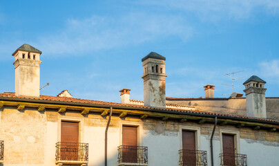 Fototapeta na wymiar Chimneys and balconies in Verona, Italy 
