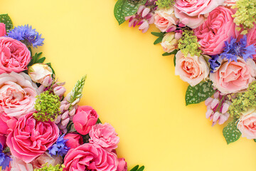 Composition of beautiful flowers, on yellow background. Flowers spring or summer frame. Colorful flowers festive background. Floral concept