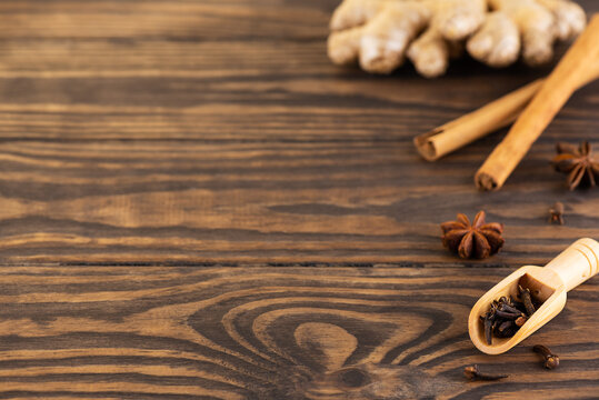 A set of spices for masala tea: cinnamon, cloves, pepper, anise, ginger. Horizontal orientation, copy space.