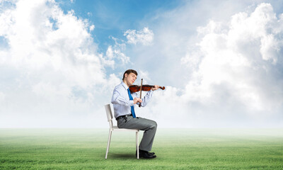 young businessman playing violin