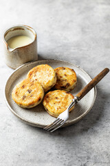 Syrniki or cottage cheese fritters with chocolate with fork on ceramics plate