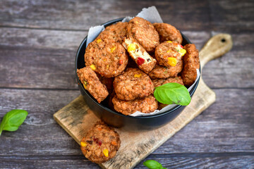 Home made  oven baked meatballs  from  chicken and vegetables and french potato  fries on  wooden background.Bifteki, or spicy meatballs 